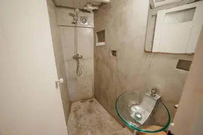a bathroom with a shower with a glass sink at Charming Tiny House by Hosty in Porto