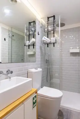 a bathroom with a toilet and a sink and a shower at Host Wise - Colourful Cozy Flat in Porto