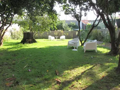 a group of white chairs sitting in a yard at Koolhouse Porto in Porto