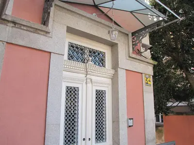 a pink and white building with a window at Koolhouse Porto in Porto