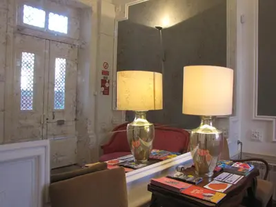 a living room with a table with two lamps on it at Koolhouse Porto in Porto