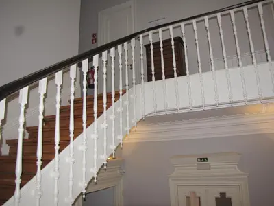 a staircase in a home with white railings at Koolhouse Porto in Porto