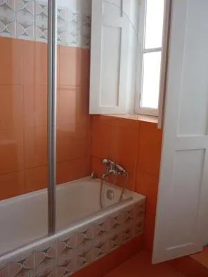 a bathroom with a bath tub and a window at Central Stonehouse with terrace in Porto