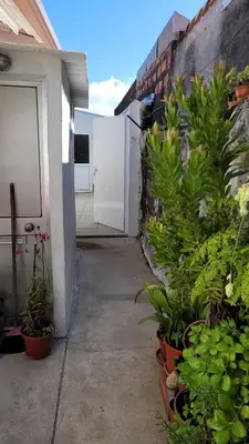 a patio with plants in pots next to a building at Guest House CR5 in Porto