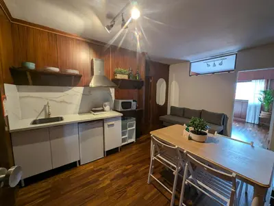 a kitchen and living room with a table and a dining room at Travel and Live Poveiros in Porto