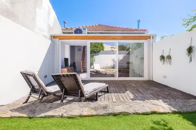 a patio with two chairs and a table at Green Tiles House in Porto