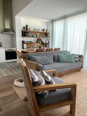 a living room with a couch and a table at Green Tiles House in Porto