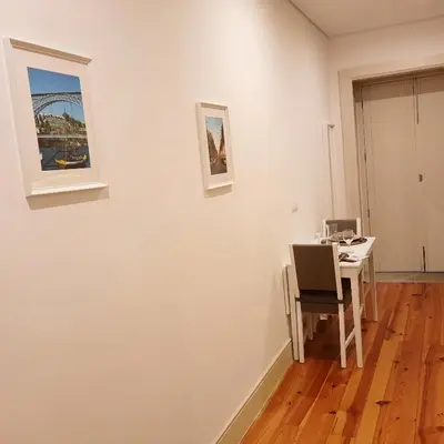 a white room with a table and a picture on the wall at Premium Apartment Porto Downtown - Bonjardim in Porto
