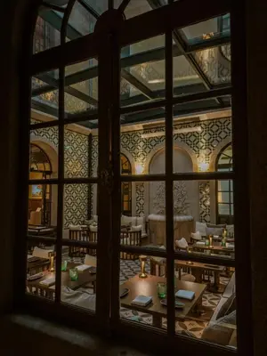a window view of a restaurant with tables and chairs at Palacete Severo in Porto