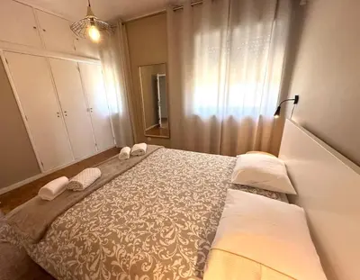 a bedroom with a bed with two towels on it at Premium Quental House - T3 Renovado com magnifico Terraço in Porto