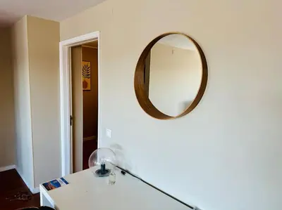 a room with a mirror on the wall and a lamp at Premium Quental House - T3 Renovado com magnifico Terraço in Porto
