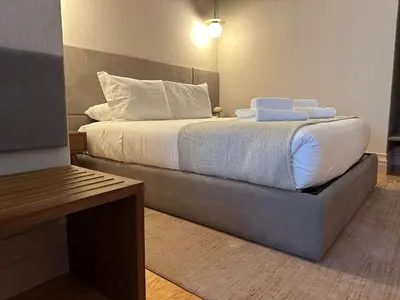 a bedroom with a bed with white sheets and pillows at Lit Apartments - CLÉRIGOS in Porto