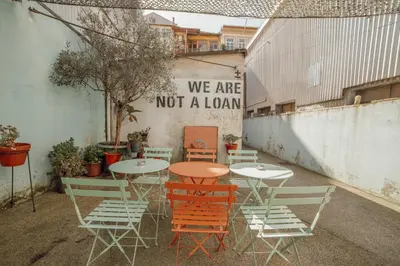 a table and chairs with a sign that says we are not a loan at Clerigos Loft by Hosty in Porto