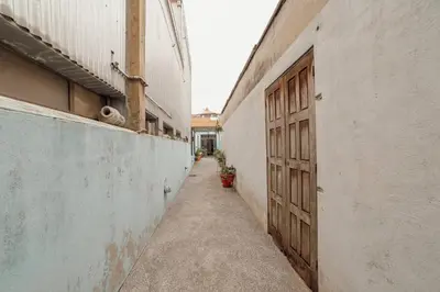 an empty alley with a wooden door in a building at Clerigos Loft by Hosty in Porto