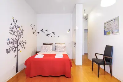 a living room with a couch and a tv at Studios Cedofeita in Porto