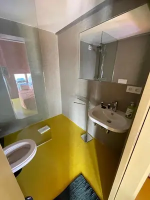 a bathroom with a white toilet and a sink at Porto Studio in Porto