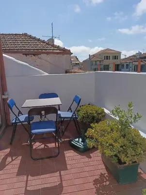 a patio with two chairs and a table on a roof at Porto Studio in Porto