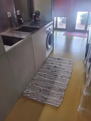 a kitchen with a sink and a washing machine at Porto Studio in Porto