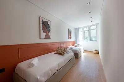 a bedroom with two beds and a couch at Doispontozero Alegria Terracotta in Porto