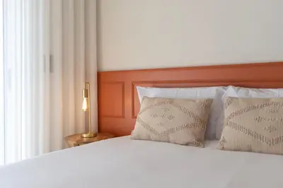 a bedroom with a white bed with two pillows at Doispontozero Alegria Terracotta in Porto