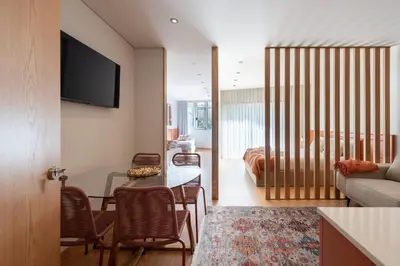 a living room with a table and a couch at Doispontozero Alegria Terracotta in Porto