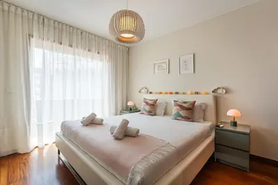 a bedroom with a large bed with a large window at GuestReady - Teddy Jazz in Porto