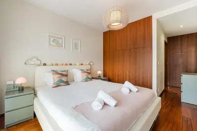 a bedroom with a large white bed with two towels at GuestReady - Teddy Jazz in Porto
