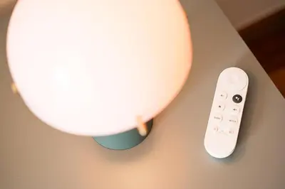a lamp and a remote control on a table at GuestReady - Teddy Jazz in Porto
