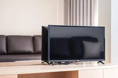 a flat screen tv sitting on top of a table at GuestReady - Mushroom in Porto
