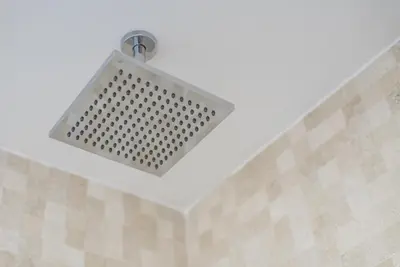 a light hanging from a ceiling in a bathroom at GuestReady - Mushroom in Porto