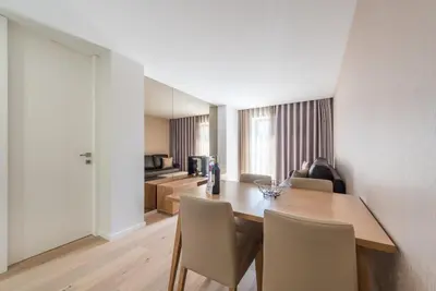 a dining room with a wooden table and chairs at GuestReady - Mushroom in Porto