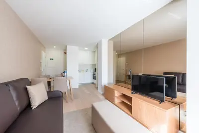 a living room with a couch and a flat screen tv at GuestReady - Mushroom in Porto