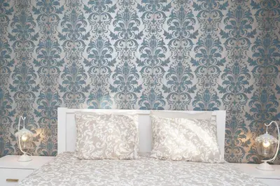 a bedroom with a bed with a damask wallpaper at GuestReady - Stylish stay with balcony in Gaia in Vila Nova de Gaia