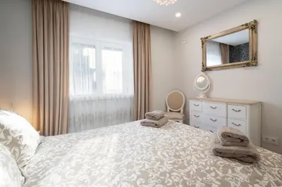 a bedroom with a bed and a mirror and a dresser at GuestReady - Stylish stay with balcony in Gaia in Vila Nova de Gaia