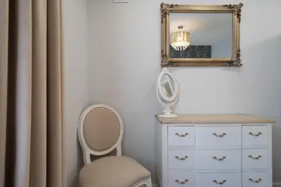 a mirror and a dresser and a chair in a room at GuestReady - Stylish stay with balcony in Gaia in Vila Nova de Gaia