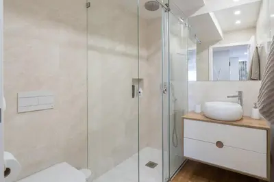 a bathroom with a glass shower stall and a sink at GuestReady - Stylish stay with balcony in Gaia in Vila Nova de Gaia