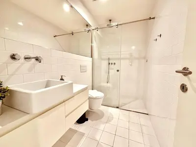 a bathroom with a sink and a toilet and a shower at Bombarda 250 E in Porto