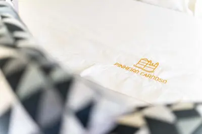 a close up of a white shirt with a logo on it at Pinheiro Cardoso in Porto