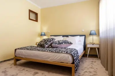 a bedroom with a bed with two pillows on it at Pinheiro Cardoso in Porto