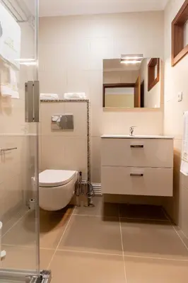 a bathroom with a toilet and a sink at Pinheiro Cardoso in Porto