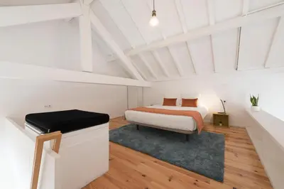a white room with a bed and a desk at Apartment Alegria Street by Sweet Porto - Free Parking in Porto