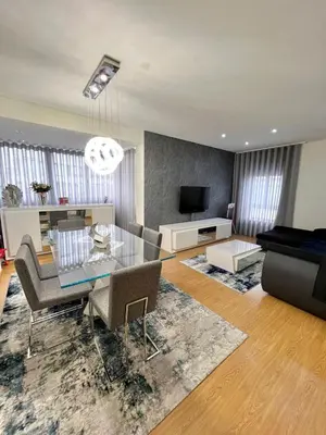 a living room with a table and chairs and a television at Douro Residence Porto Gaia in Vila Nova de Gaia