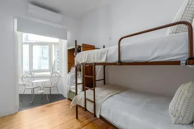 a bedroom with a bunk bed and a desk in it at St Catarina 555 Apartment in Porto