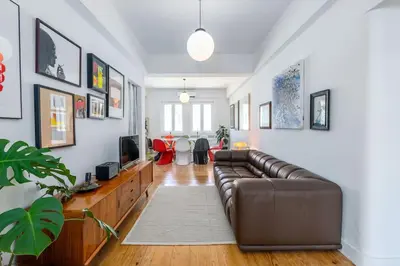 a living room with a leather couch and a tv at St Catarina 555 Apartment in Porto