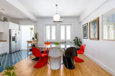 a dining room with a table and red chairs at St Catarina 555 Apartment in Porto
