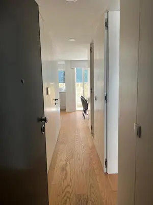 an empty hallway with a chair in a room at Cozy Retreat - Modern T1 in Porto