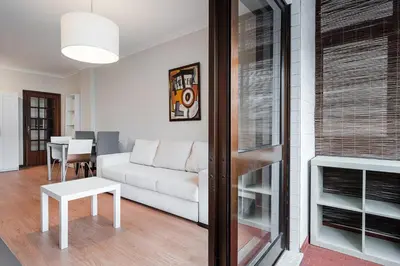 a living room with a white couch and a table at GuestReady - Central Porto Gem in Porto