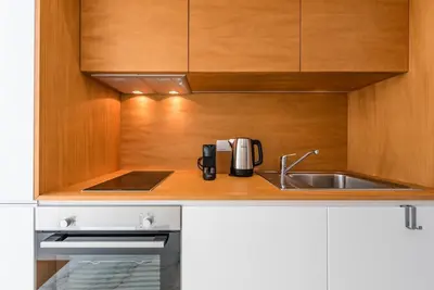 a kitchen with a sink and a coffee maker at GuestReady - Blueberry Pie in the Balcony in Porto