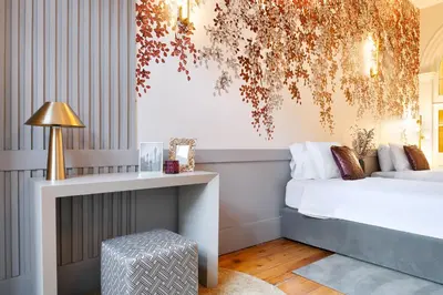 a bedroom with a bed and a table with a chair at 42 2 F Historical apartment at Cardosas Block in Porto