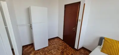 a small room with a door and a room with a bed at Leote in Porto
